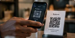Customer paying by scanning a Zapapa QR code stand with a phone
