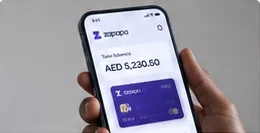 Hand holding a phone with the Zapapa app and virtual card