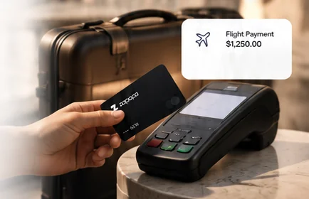 Hand tapping a black Zapapa card on a payment terminal next to a suitcase, with a $1,250.00 flight payment notification